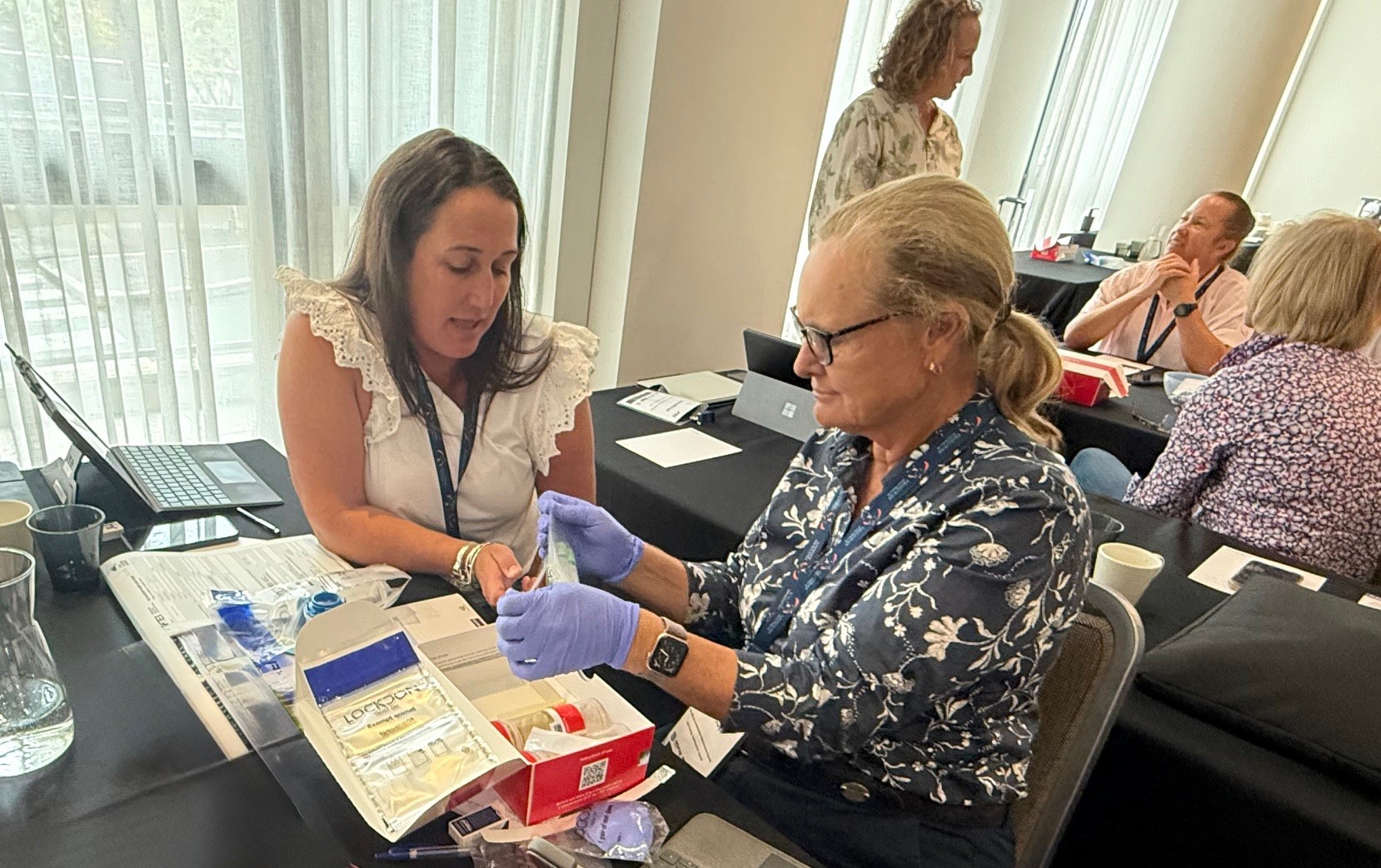 Dr Penny Dow NMCO and Dr Janine Dywer examine new FEI Testing Kits